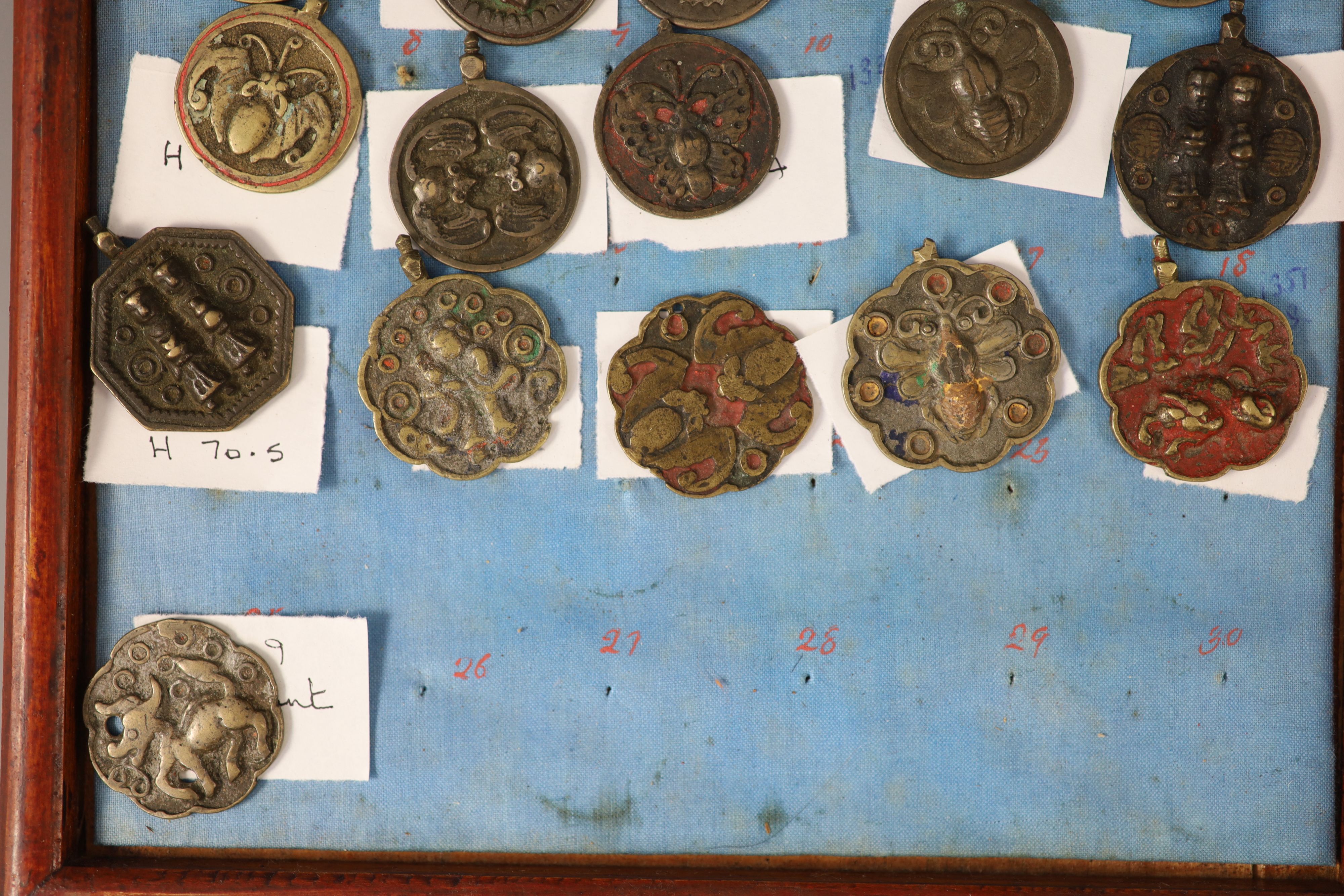 A group of 99 Korean bronze and metal amulets or charms, 19th/20th century